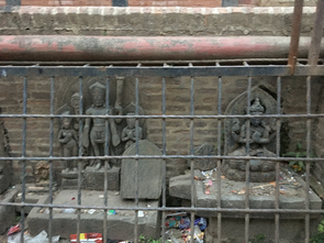 Statues protected by bars at Chysal Hiti, Patan.