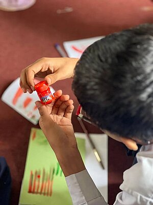 A participant from a collaborating school taking part in a coloring workshop.