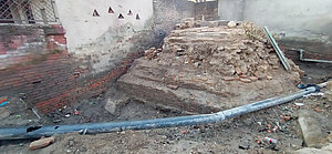 The ruins of temple with constant interference of pipelines from the city's infrastructure department damaging its plinth and structure.