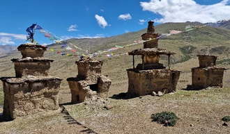 Four Buddhist chortens (stupas) in front of a gompa in Dho valley.