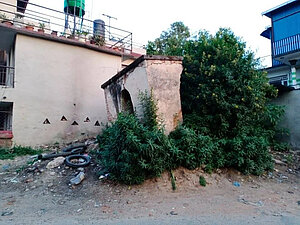 Glass, garbage and vegetation around the Bramha Temple ruins.