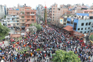 View from Labim Mall’s roof onto Pulchok, where four phalcās as well as parts of the Janāḥkhyaḥ Metro Park can be seen while the procession has just set off.