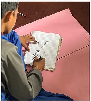 A participant from a collaborating school working on designing a game based on the graphic novel.